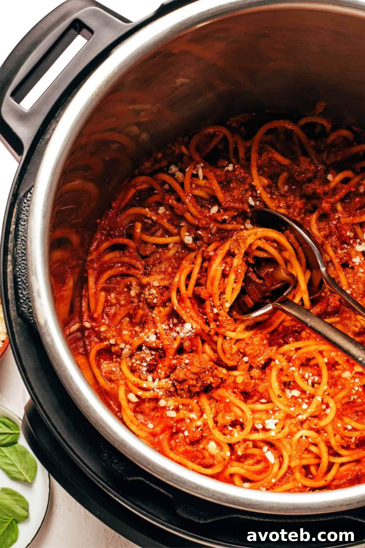 Delicious High Protein Instant Pot Spaghetti served in a bowl, garnished with fresh basil.