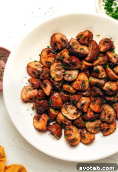 A vibrant close-up of Air Fryer Mushrooms, golden brown and seasoned.