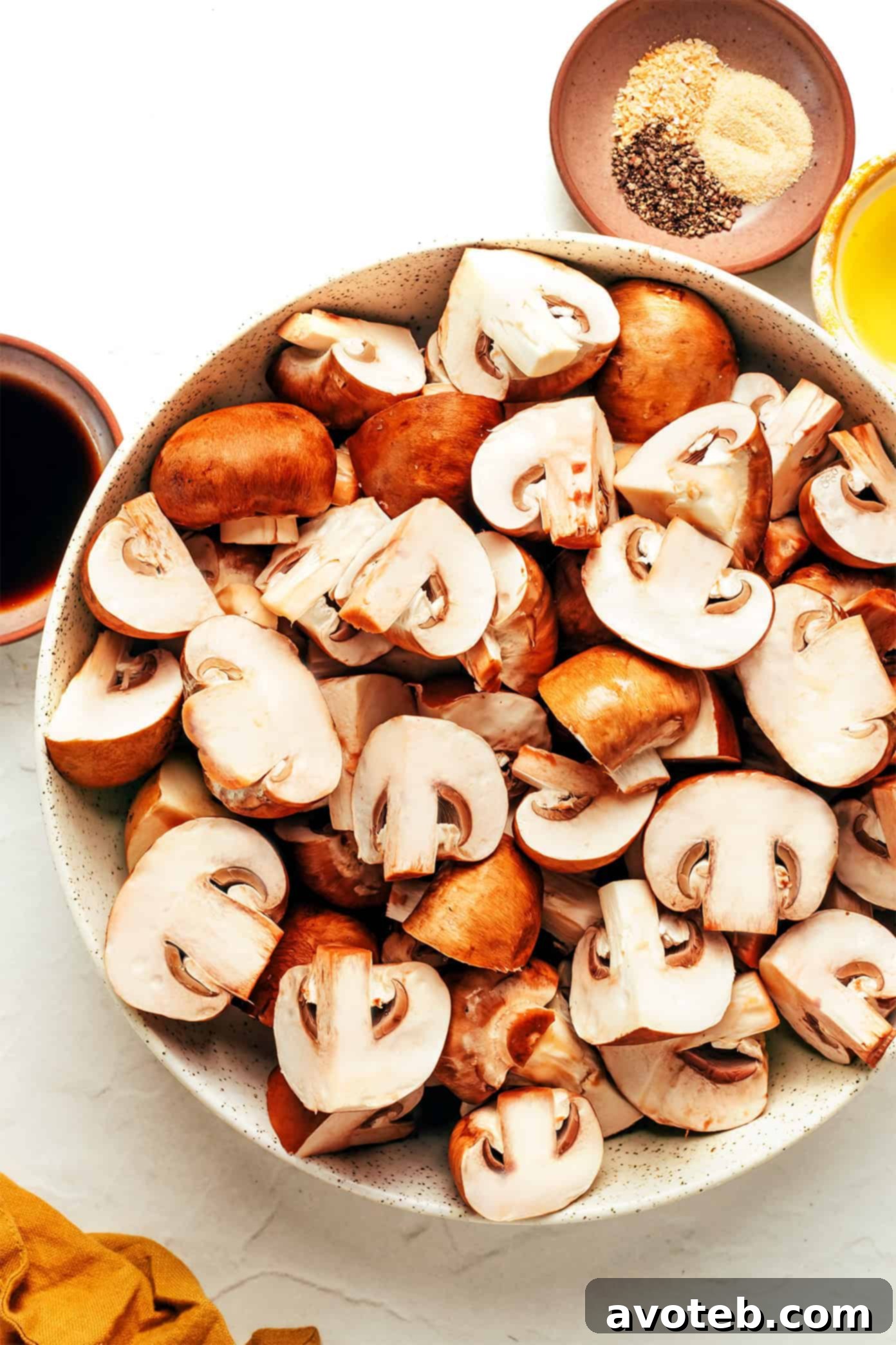 Assortment of seasoned baby bella mushrooms before air frying.