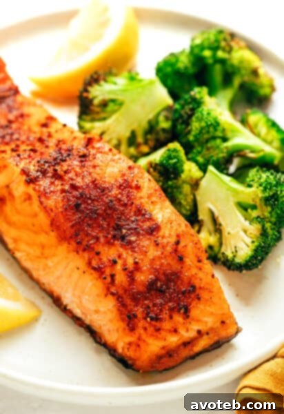 Air Fryer Salmon fillets seasoned and ready for cooking, served with fresh lemon wedges.