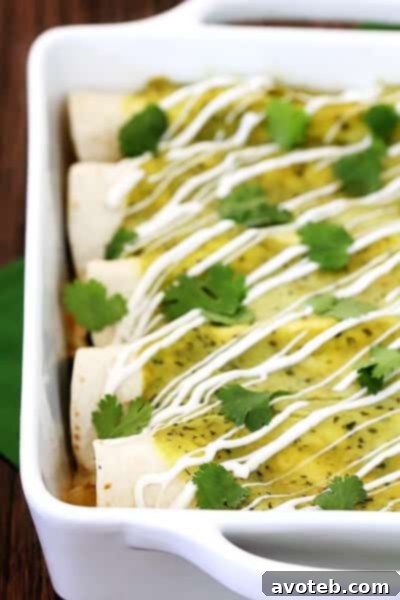 Chicken & Avocado Enchiladas | gimmesomeoven.com Close-up of baked Chicken and Avocado Enchiladas