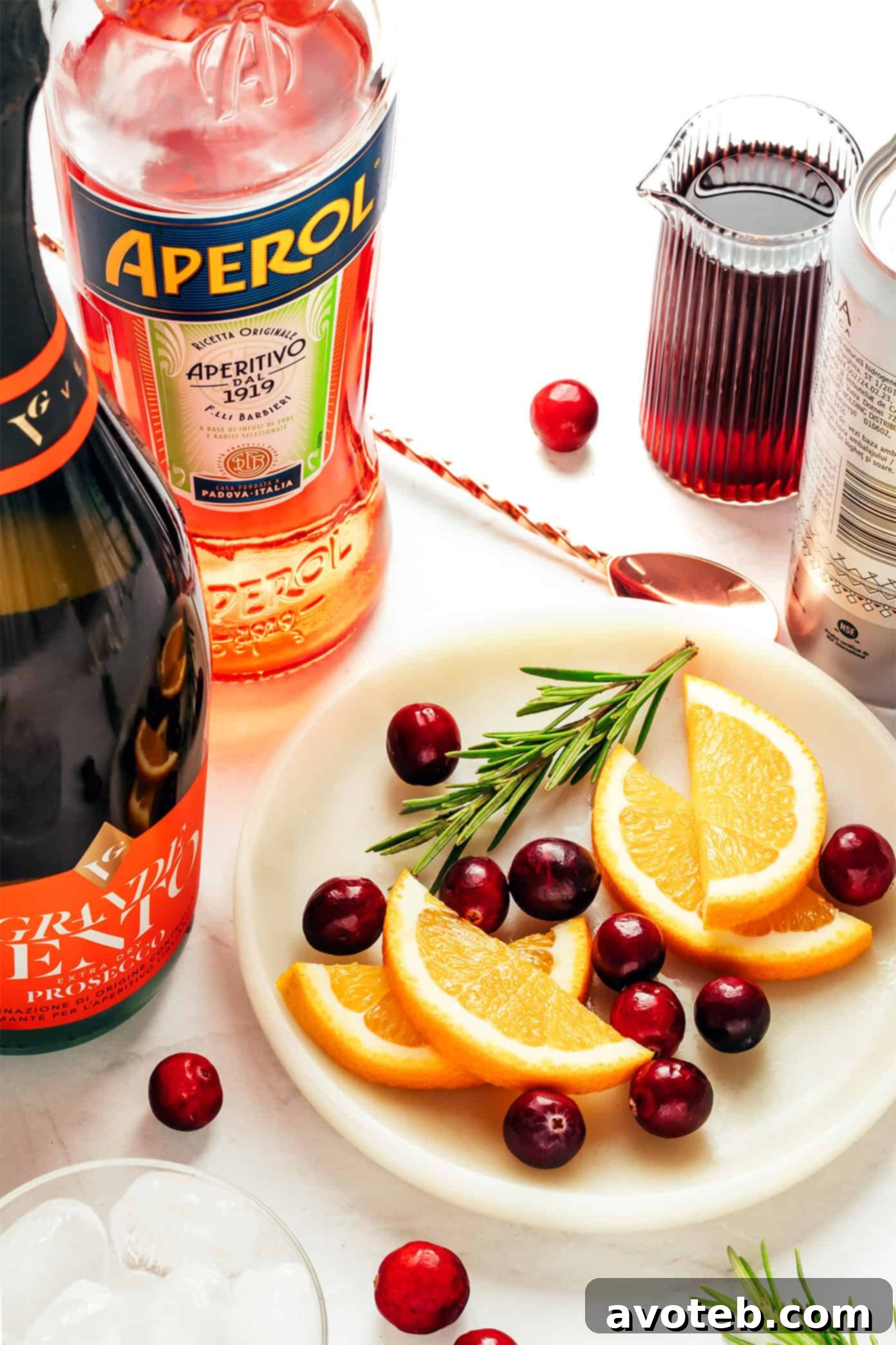 Hands holding two glasses of Cranberry Aperol Spritz, clinking in a toast, festive and inviting.