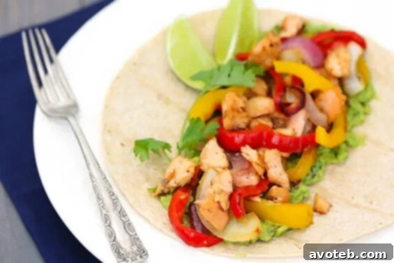 Sizzling Salmon Fajitas served on a skillet with fresh ingredients.