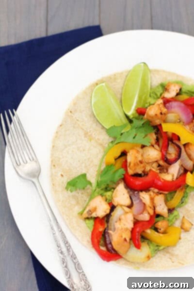 Cooked salmon fajitas with vegetables and fresh lime wedges.