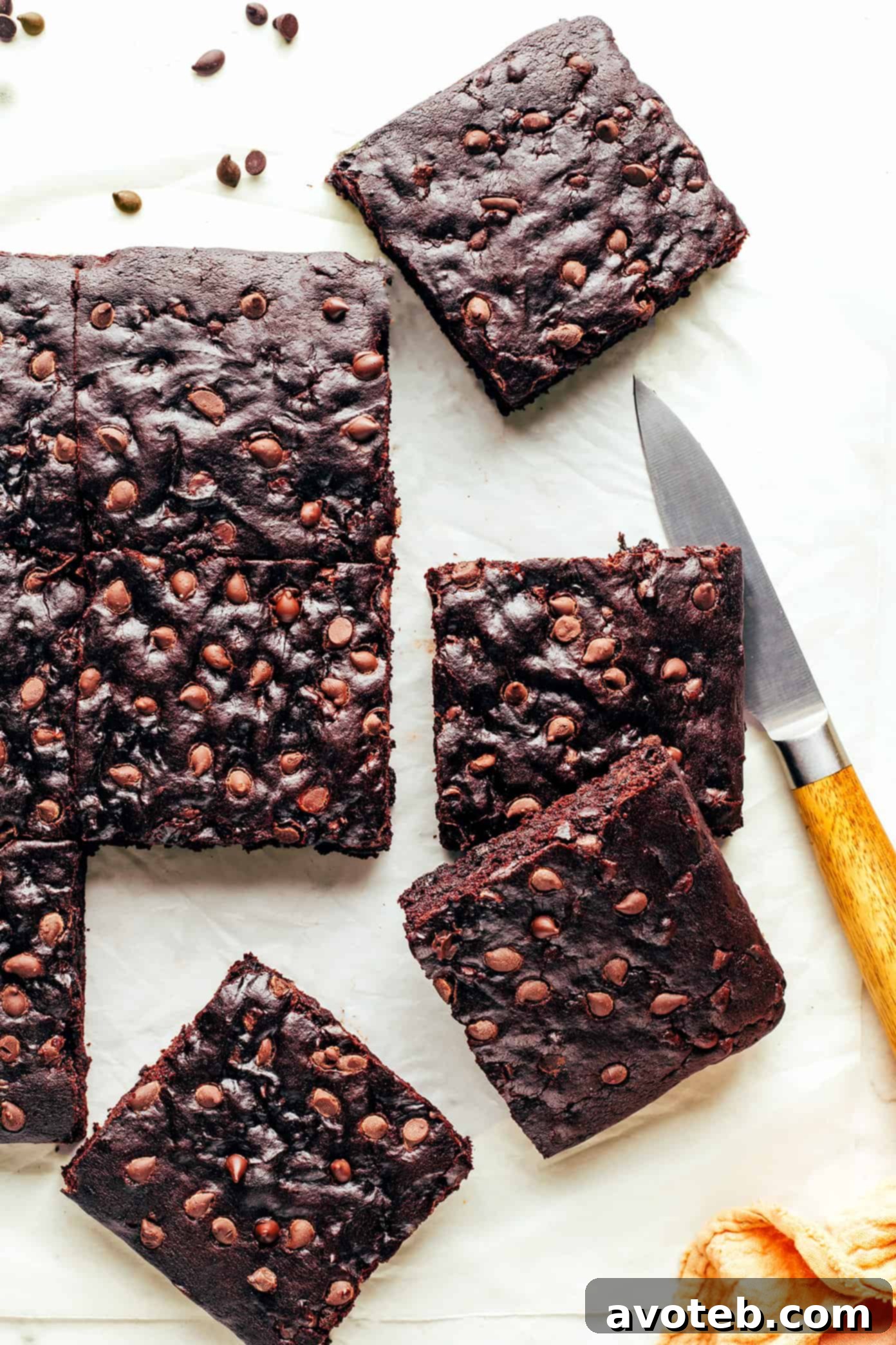 A freshly baked pan of vegan brownies, with a few pieces already cut out.