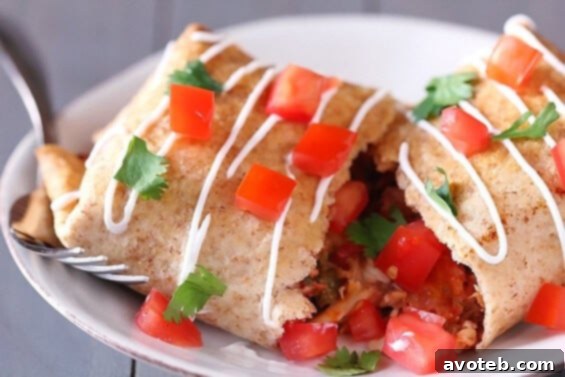A stack of perfectly baked chicken chimichangas on a cutting board, garnished with cilantro.