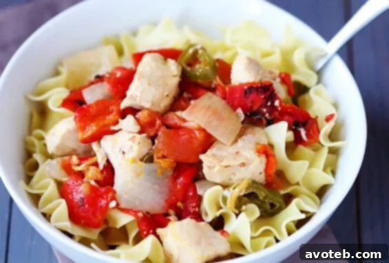 Delicious Easy Chicken Cacciatore cooked in a slow cooker, served over egg noodles.