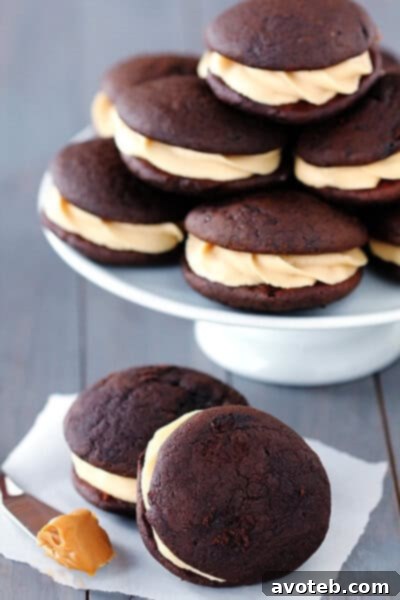 Close-up shot of a Chocolate Biscoff Whoopie Pie, showing the creamy frosting and soft chocolate cookie texture.