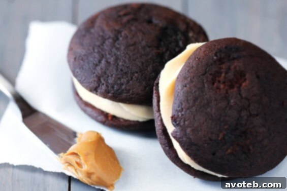 A side view of Chocolate Biscoff Whoopie Pies arranged on a serving plate.