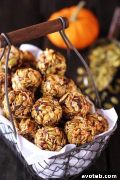 Hand holding a Pumpkin No-Bake Energy Bite, ready to be eaten