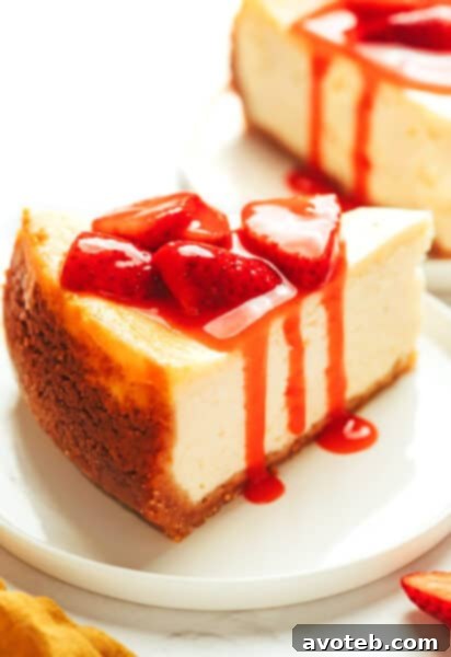 A beautifully styled image of a glass bowl filled with fresh homemade strawberry sauce, ready to be served, with a spoon resting in it.