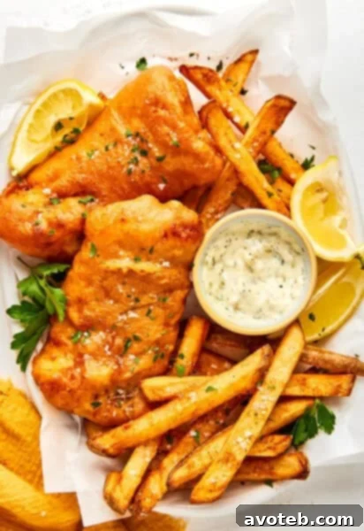 Crispy Old Bay Fish and Chips served with fresh lemon, parsley, and tartar sauce.