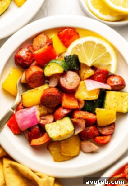 A bowl of air-fried Old Bay sausage and colorful vegetables.